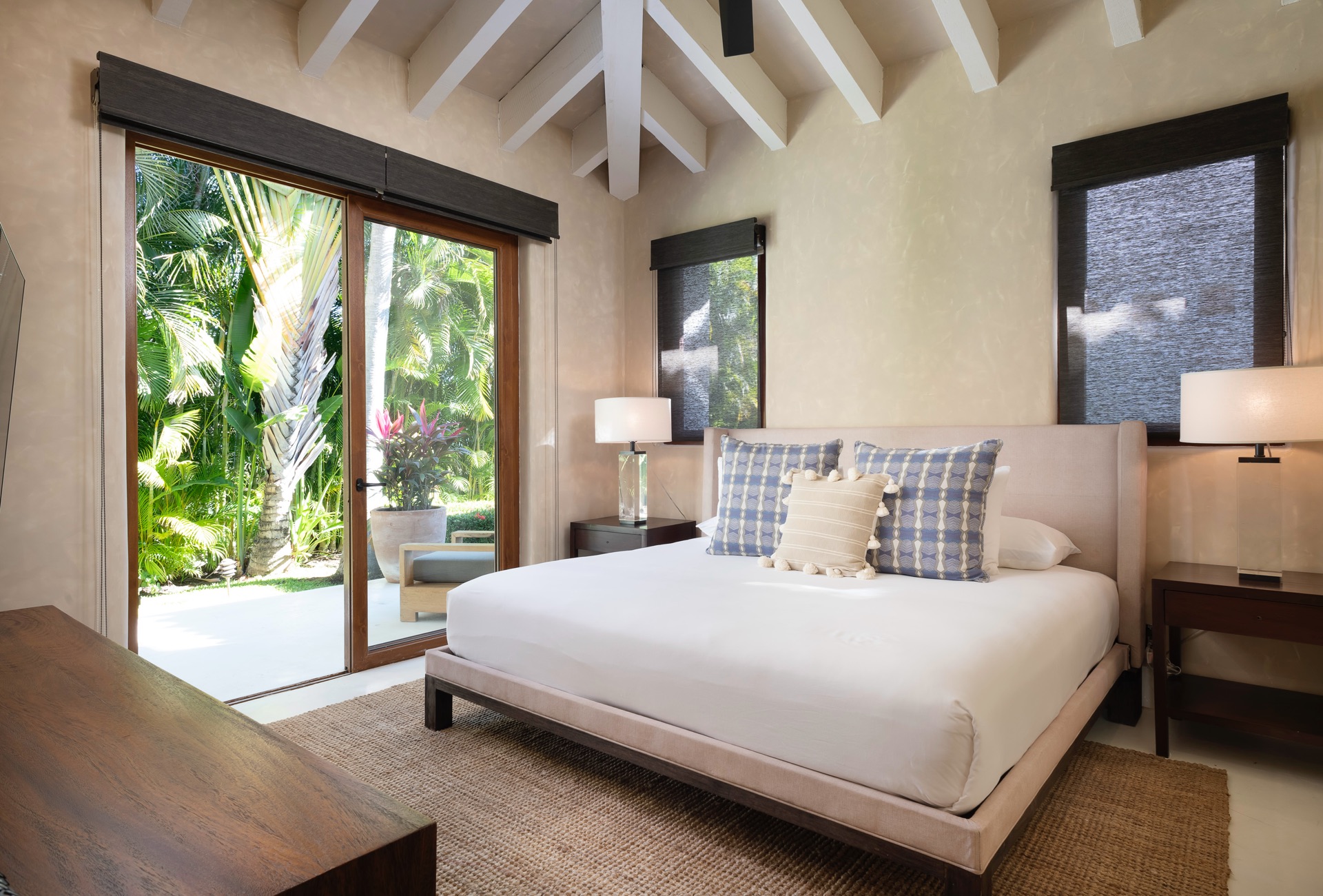 An alluring image of Villa Pacifica with its sparkling pool, inviting lounge chairs, lush gardens, and a banner saying "Summer Vacation.